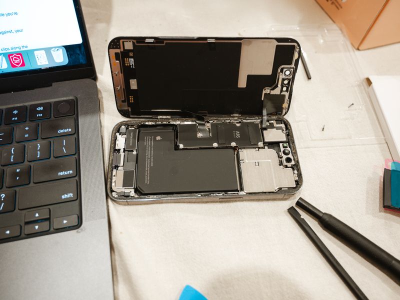 Technician replacing phone battery
