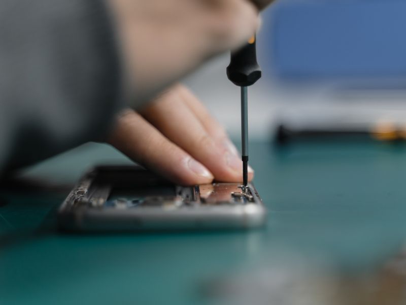 Technician performing screen repair